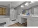 Bathroom with dual sinks, a tub, and a glass-enclosed shower at 15 Skipton Ct, Sharpsburg, GA 30277