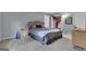 Bright bedroom with a large bed, a ceiling fan, and a well-organized closet at 15 Skipton Ct, Sharpsburg, GA 30277