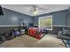 Bedroom featuring two-tone walls, a ceiling fan, and a large window with natural light at 15 Skipton Ct, Sharpsburg, GA 30277
