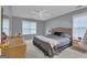 Comfortable bedroom with ample natural light, a ceiling fan, and neutral-toned walls at 15 Skipton Ct, Sharpsburg, GA 30277