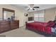 Comfortable bedroom with a large bed, dresser, and neutral decor at 15 Skipton Ct, Sharpsburg, GA 30277