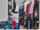 Walk-in closet with built-in shelving and ample storage for clothes and accessories at 15 Skipton Ct, Sharpsburg, GA 30277