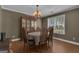Traditional dining room with classic chandelier and large window at 15 Skipton Ct, Sharpsburg, GA 30277
