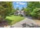 Long driveway leading to a well-maintained home with lush green lawn at 15 Skipton Ct, Sharpsburg, GA 30277