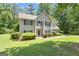 Charming two-story home featuring a well-manicured lawn and classic shutters at 15 Skipton Ct, Sharpsburg, GA 30277