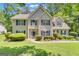 Charming two-story home featuring a well-manicured lawn and classic shutters at 15 Skipton Ct, Sharpsburg, GA 30277