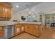 Kitchen with stainless appliances, granite countertops, and wooden cabinets open to living space at 15 Skipton Ct, Sharpsburg, GA 30277
