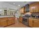 Open-concept kitchen with stainless steel appliances and bar that opens to a living space at 15 Skipton Ct, Sharpsburg, GA 30277
