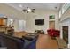 Open living room showcasing vaulted ceilings, a fireplace, and seamless flow to other spaces at 15 Skipton Ct, Sharpsburg, GA 30277