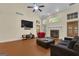 Inviting living room featuring a fireplace, large windows, and vaulted ceilings with fan at 15 Skipton Ct, Sharpsburg, GA 30277