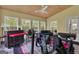 Bright sunroom with lots of windows, exercise equipment, and ceiling fan at 15 Skipton Ct, Sharpsburg, GA 30277