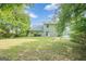 Exterior view of the backyard showing a lush green lawn and beautiful blue sky at 2576 Abbotts Glen Nw Dr, Acworth, GA 30101