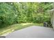 Backyard with a concrete patio and lush green trees, offering a serene outdoor space at 2576 Abbotts Glen Nw Dr, Acworth, GA 30101