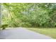 Backyard featuring a concrete patio, mature trees, and a well-maintained lawn at 2576 Abbotts Glen Nw Dr, Acworth, GA 30101