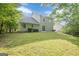 Exterior view of the home's backyard with grass and trees, offering a spacious outdoor area at 2576 Abbotts Glen Nw Dr, Acworth, GA 30101