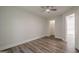 Bedroom offers wood-look flooring, a ceiling fan, closet space, and natural light from a window at 2576 Abbotts Glen Nw Dr, Acworth, GA 30101