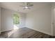 A bright bedroom featuring wood-look flooring, a ceiling fan, and a window providing natural light at 2576 Abbotts Glen Nw Dr, Acworth, GA 30101