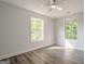Light filled bedroom with hardwood floors and two windows for natural light at 2576 Abbotts Glen Nw Dr, Acworth, GA 30101