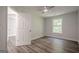 Cozy bedroom featuring wood-look flooring, natural light from a window, and a ceiling fan at 2576 Abbotts Glen Nw Dr, Acworth, GA 30101