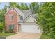 Charming two-story home featuring brick accents, a two-car garage, and a white front door at 2576 Abbotts Glen Nw Dr, Acworth, GA 30101