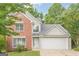 Charming two-story home featuring brick accents, a two-car garage, and a well-maintained front lawn at 2576 Abbotts Glen Nw Dr, Acworth, GA 30101