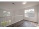 Bright hallway features hardwood floors, white railing, and lots of natural light at 2576 Abbotts Glen Nw Dr, Acworth, GA 30101