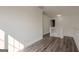 Upstairs hall with hard wood floors, white walls, and a sunlit view to downstairs at 2576 Abbotts Glen Nw Dr, Acworth, GA 30101