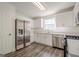 Modern kitchen with stainless steel appliances, white cabinets, and hardwood floors at 2576 Abbotts Glen Nw Dr, Acworth, GA 30101