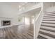 Bright living room featuring high ceilings, a fireplace, wood floors, and a staircase to the upper level at 2576 Abbotts Glen Nw Dr, Acworth, GA 30101