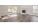 Bright living room featuring a fireplace, hardwood floors, and a large window with natural light at 2576 Abbotts Glen Nw Dr, Acworth, GA 30101