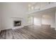 Bright living room featuring high ceilings, a fireplace, wood floors, and a large window at 2576 Abbotts Glen Nw Dr, Acworth, GA 30101
