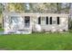 Charming single-story home with white brick, black shutters, manicured lawn, and a welcoming front entrance at 914 Mercury Nw Dr, Atlanta, GA 30331