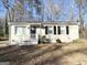 Well-maintained single-story home featuring a brick facade, black shutters, and a neatly landscaped front yard at 914 Mercury Nw Dr, Atlanta, GA 30331