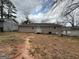 A view of the backyard featuring a house, partial patio, and a detached garage at 1068 Longshore Dr, Decatur, GA 30032
