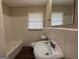 A white bathroom with tile walls, dark wood flooring, tub/shower combination and a wide mirror at 1068 Longshore Dr, Decatur, GA 30032