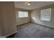 A carpeted bedroom with two windows providing natural light at 1068 Longshore Dr, Decatur, GA 30032