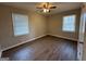 A bedroom with light-colored walls and wood flooring and two windows at 1068 Longshore Dr, Decatur, GA 30032