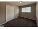 A cozy bedroom featuring plush carpeting, a window, and a closet at 1068 Longshore Dr, Decatur, GA 30032