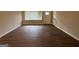 A simple living room with wood flooring and neutral walls at 1068 Longshore Dr, Decatur, GA 30032
