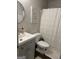 Modern bathroom with a stylish vanity, round mirror, and a shower-tub combination at 517 Pebble Pt, Loganville, GA 30052