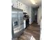 Efficient kitchen with stainless steel appliances, white cabinets, and wood-look flooring at 517 Pebble Pt, Loganville, GA 30052