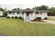 Cozy single-story home featuring a covered front porch, well-maintained lawn, and classic window shutters at 64 Gregory Ct, Dallas, GA 30157