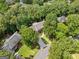 Aerial view of a residence showcasing its manicured lawn, mature trees, driveway, and neighborhood setting at 335 S Satinwood Pl, Roswell, GA 30076