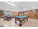 Finished basement with a pool table, comfortable seating area, and wood paneling at 335 S Satinwood Pl, Roswell, GA 30076