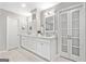 Well lit bathroom featuring double vanity with ample cabinet space and neutral paint at 335 S Satinwood Pl, Roswell, GA 30076