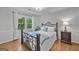 This cozy bedroom offers natural light, wood floors, and neutral paint at 335 S Satinwood Pl, Roswell, GA 30076