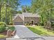 Beautiful two-story brick home featuring a well-manicured front yard and a spacious driveway leading to a two-car garage at 335 S Satinwood Pl, Roswell, GA 30076
