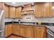 Close-up view of the kitchen's custom cabinets, granite countertops, and professional-grade cooktop at 335 S Satinwood Pl, Roswell, GA 30076