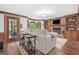 Inviting living room features hardwood floors, a brick fireplace, built-in shelving, and a bay window at 335 S Satinwood Pl, Roswell, GA 30076