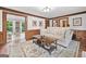 Bright living room with hardwood floors, a comfortable sofa, and wood trim at 335 S Satinwood Pl, Roswell, GA 30076